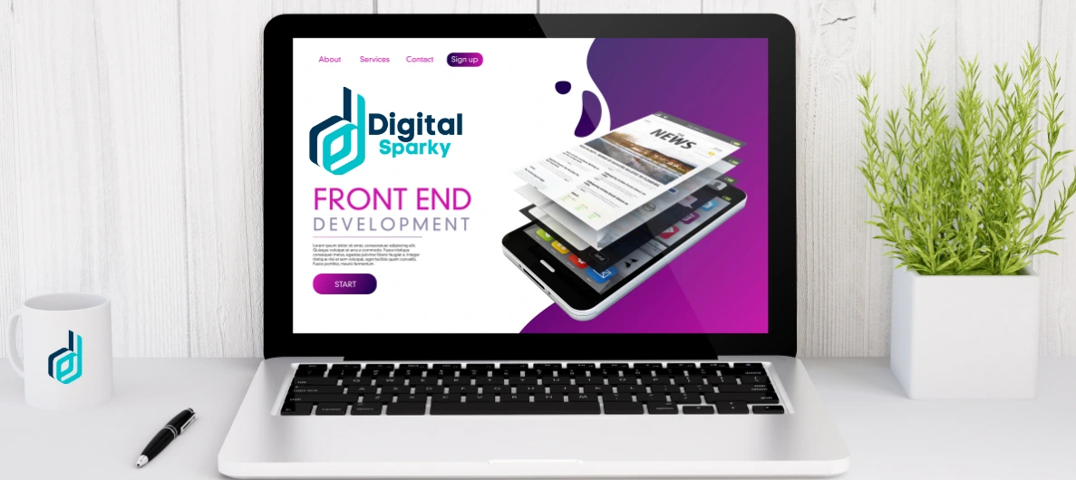 A laptop displaying the 'Digital Sparky Front End Development' website with a phone showing layered news articles, alongside a mug with the Digital Sparky logo and a green plant.